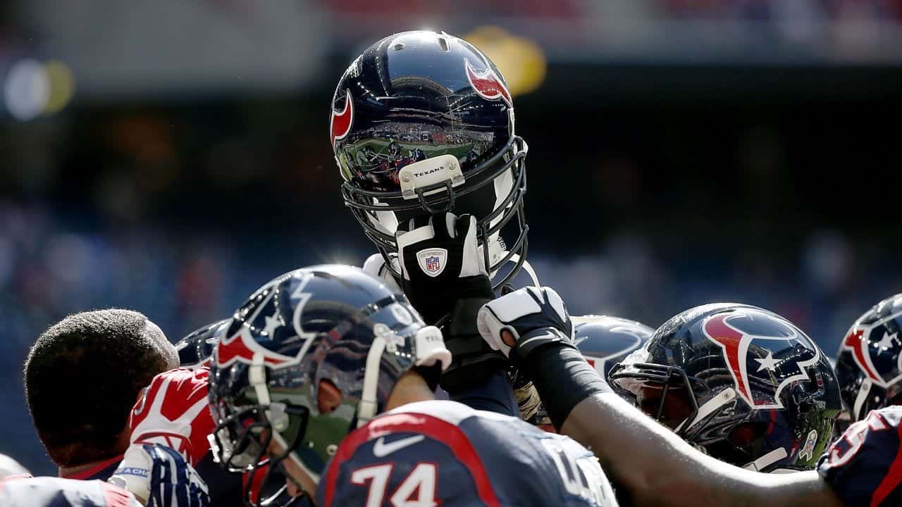 The Houston Texans huddle on the field before a preseason NFL