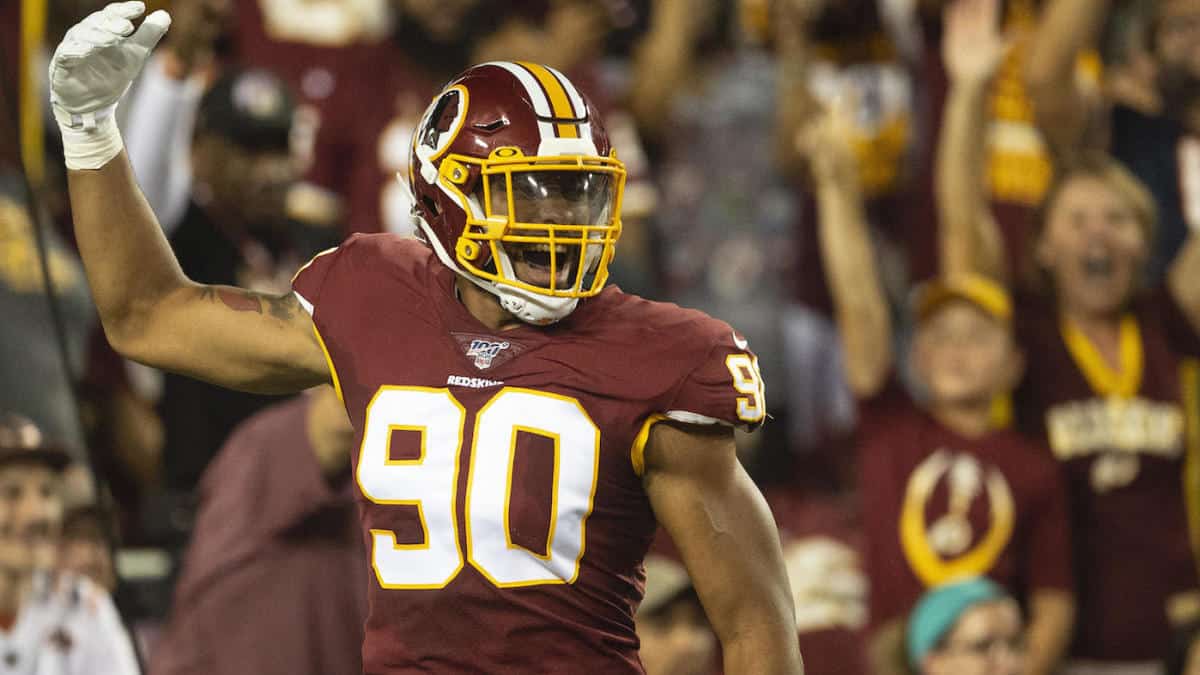 Washington Football Team defensive end Montez Sweat (90) goes up