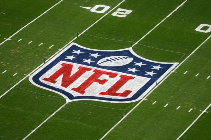 A NFL Shield logo on the flag football field at Allegiant Stadium.