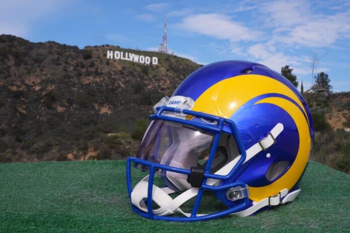 The helmet of the Los Angeles Rams displayed with the Hollywood sign in the background.
