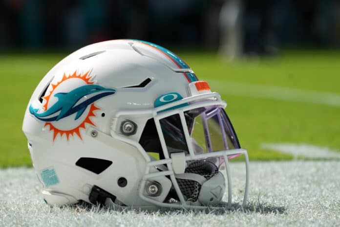 The Miami Dolphins helmet pictured on the sidelines of the field.