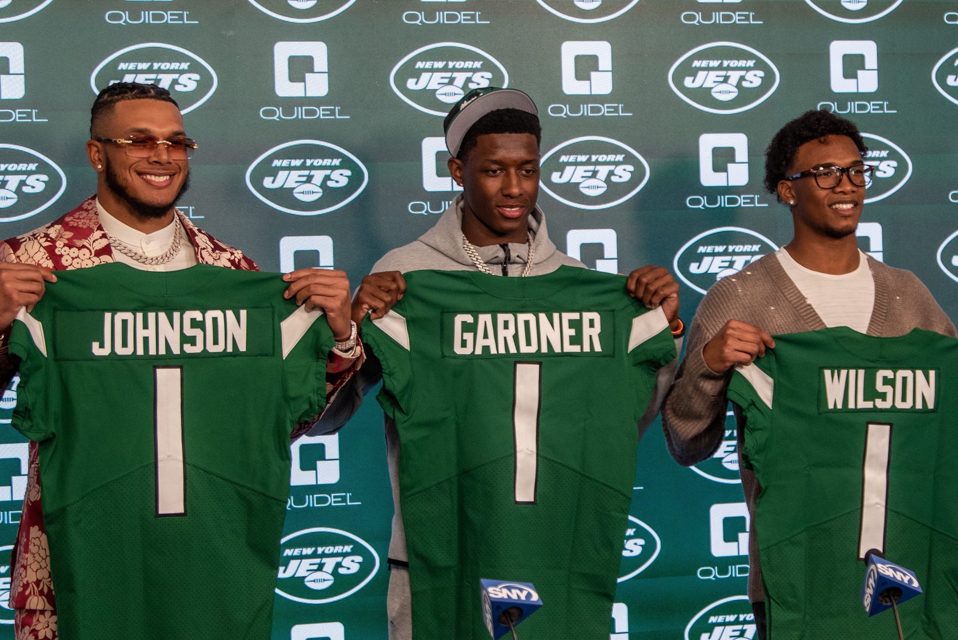 First-round picks in 2022 by the New York Jets, Jermaine Johnson (left), Sauce Gardner (middle), and Garrett Wilson (right) pose for pictures at an introductory press conference.