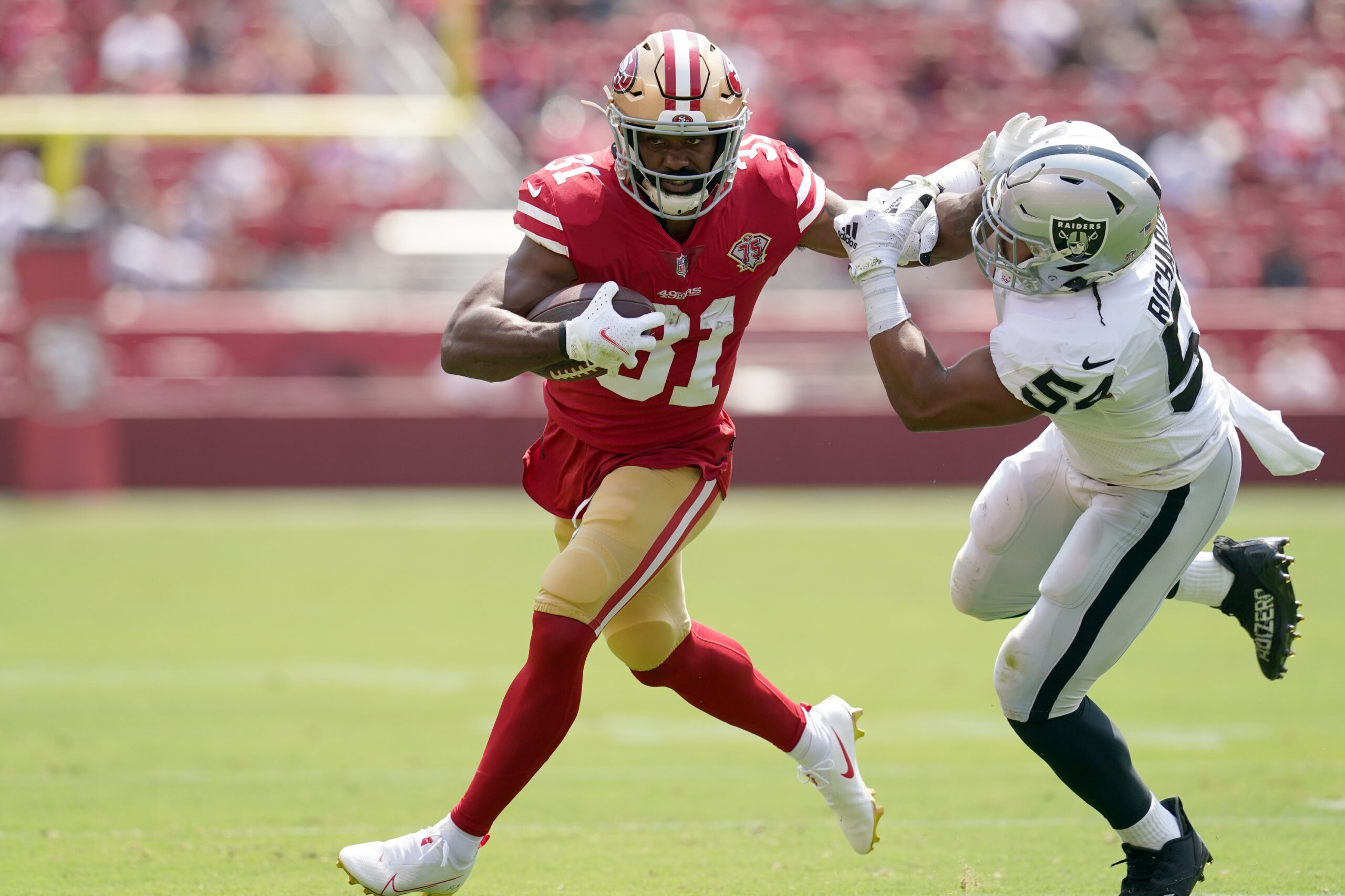 Miami Dolphins running back Raheem Mostert (31) runs with the ball