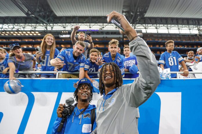 Jameson Williams takes a selfie with fans after open practice at Family Fest at Ford Field.