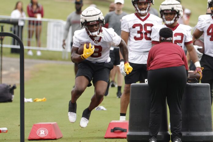 Brian Robinson (with his big hat) drives Commanders past Falcons