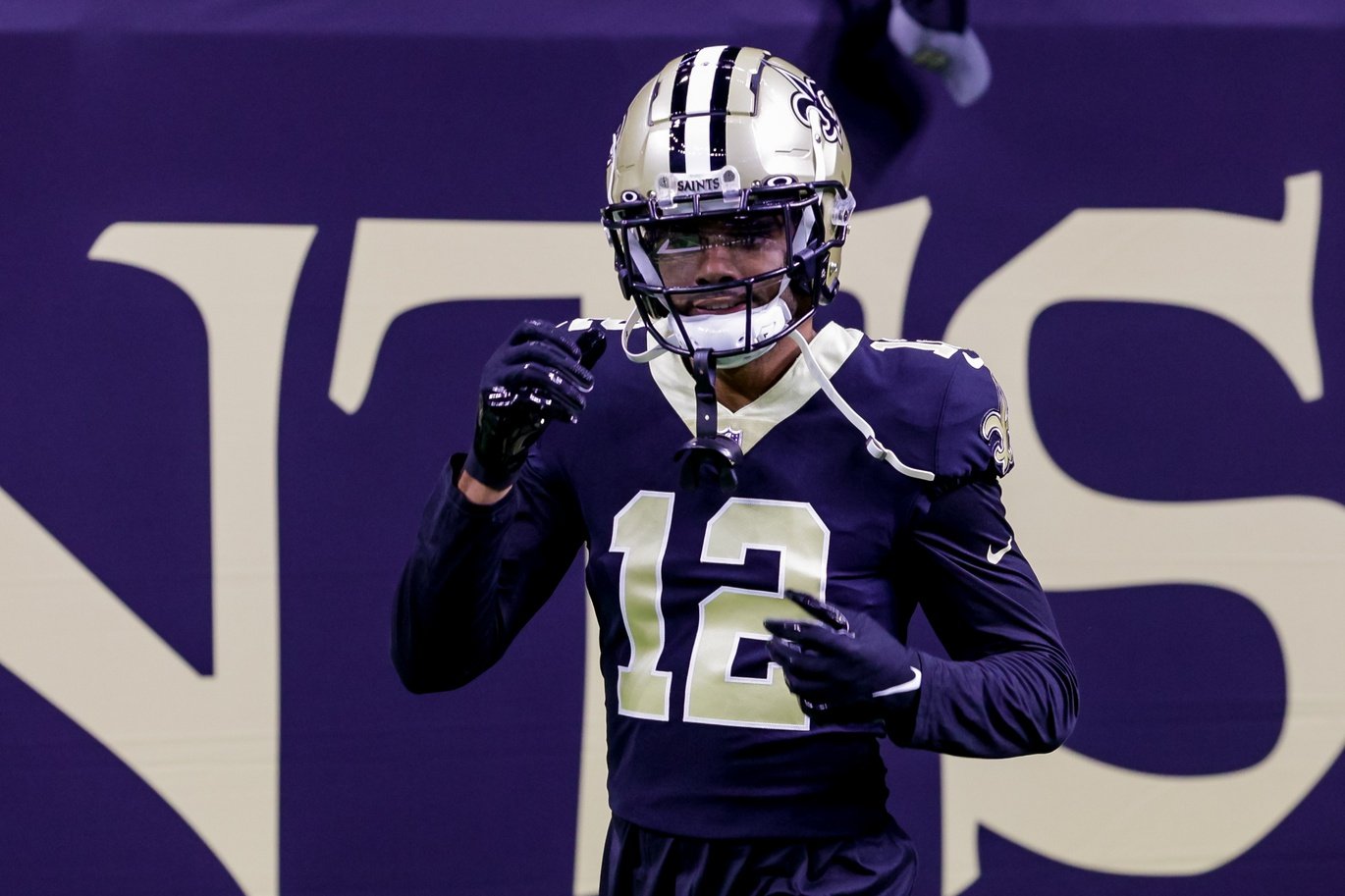 New Orleans Saints wide receiver Chris Olave wears his helmet