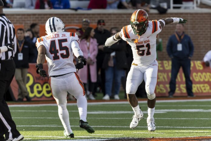 Aubrey Miller Jr. amd Isaiah Land celebrate after a sack against the National squad during the second half of the Senior Bowl.