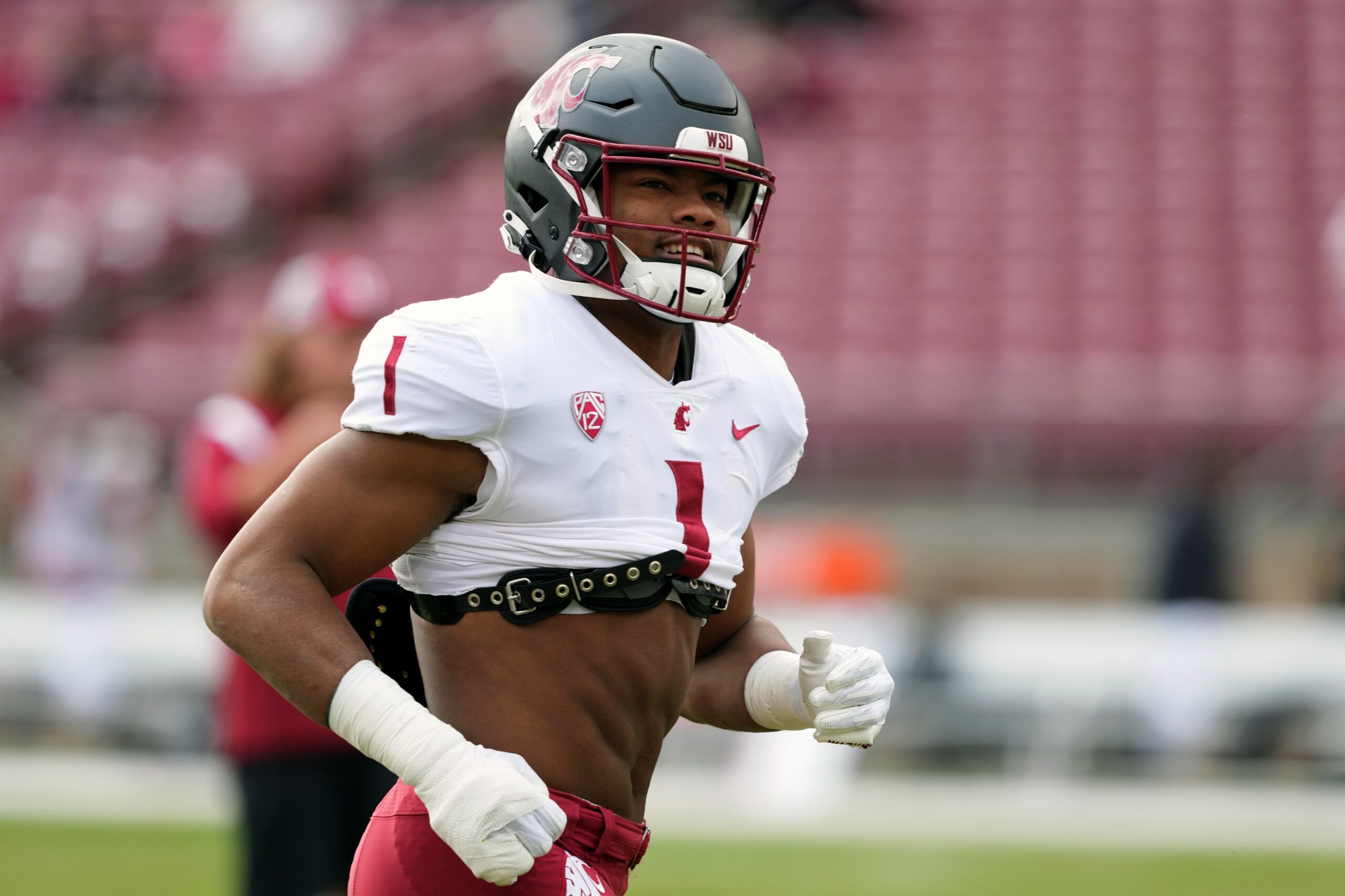 Washington State linebacker Daiyan Henley looks to the sideline