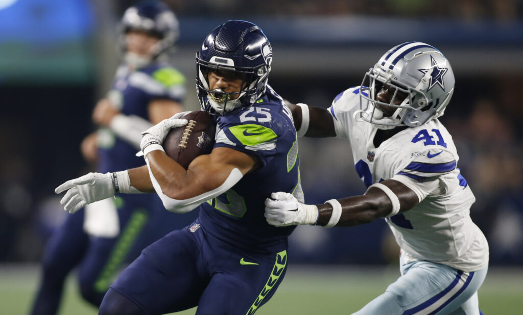 Travis Homer of the Seattle Seahawks looks on before their game