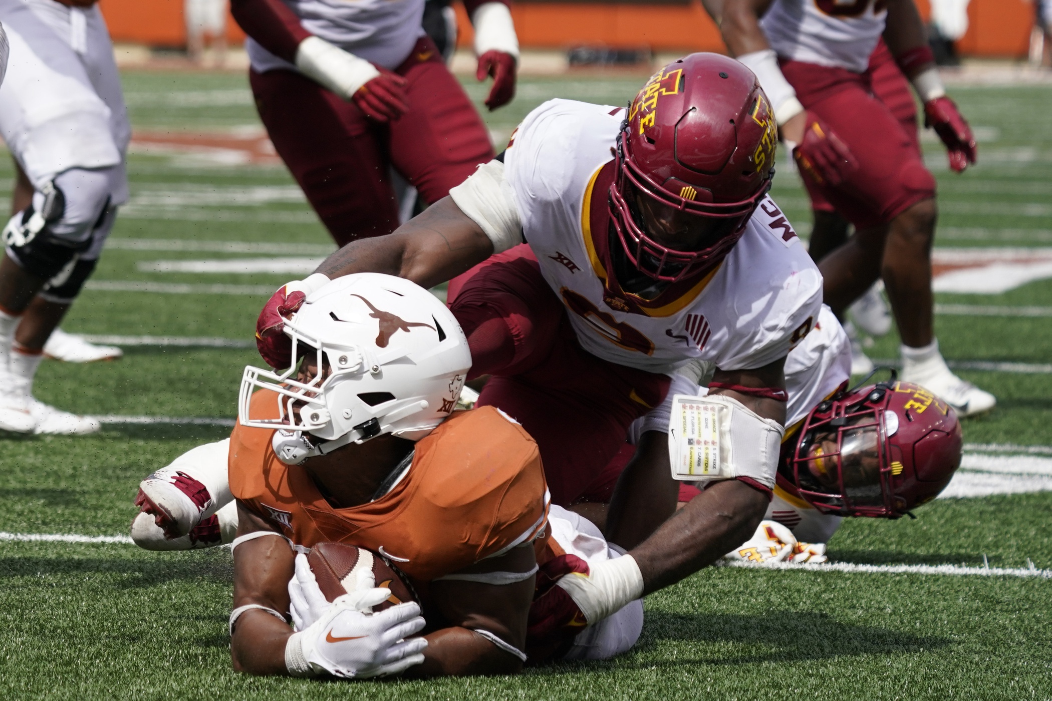 Iowa State linebacker Will McDonald, right, sacks Kansas