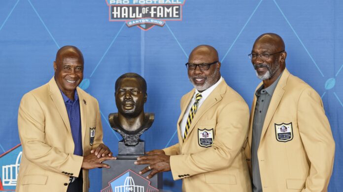 Lynn Swann, Donnie Shell, and John Stallworth pose during the induction ceremony at the Pro Football Hall of Fame.