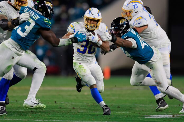 Los Angeles Chargers RB Austin Ekeler (30) rushes through the Jaguars' defense.