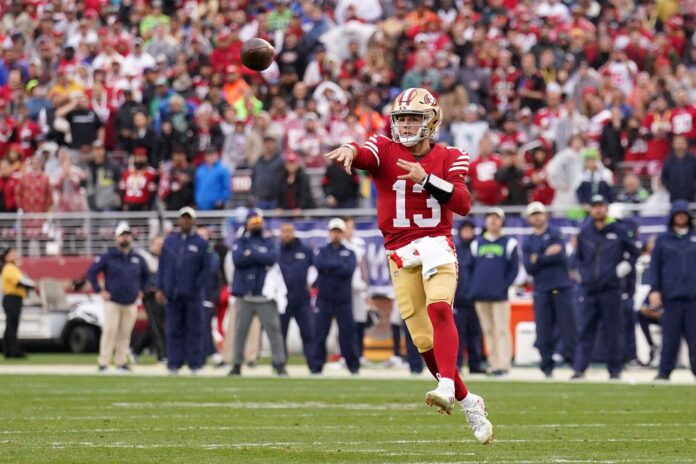 San Francisco 49ers QB Brock Purdy throws a pass in a playoff game vs. the Seattle Seahawks.