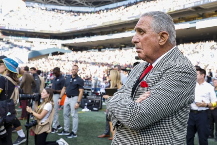 Atlanta Falcons owner Arthur Blank watches the game from the sidelines.