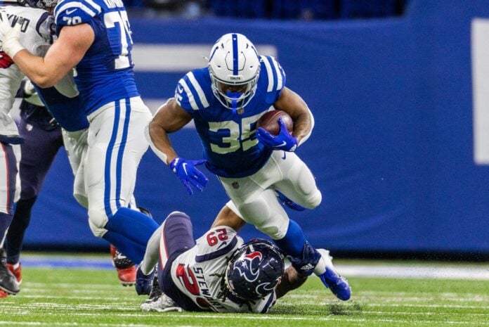 Indianapolis Colts RB Deon Jackson (35) runs over a Houston Texans defender.