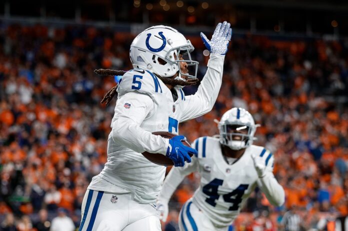 Stephon Gilmore reacts after an interception in the fourth quarter against the Denver Broncos.