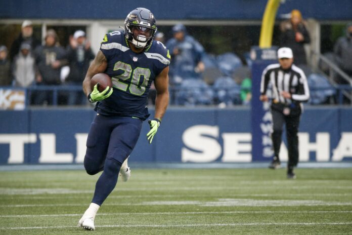 Seattle Seahawks running back Rashaad Penny (20) rushes against the Detroit Lions during the second quarter at Lumen Field.