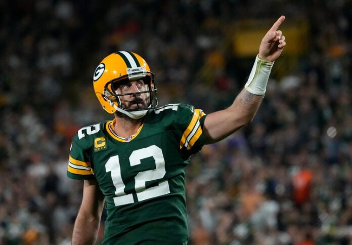 Aaron Rodgers celebrates after rushing for a first down during the fourth quarter of their game against the Chicago Bears.