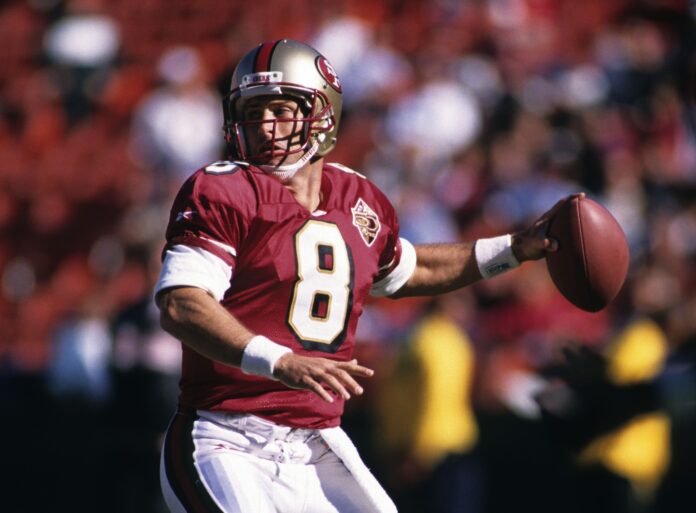 San Francisco 49ers quarterback Steve Young steps back to attempt a pass.