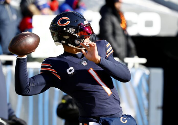Chicago Bears QB Justin Fields winds up to launch a pass downfield.