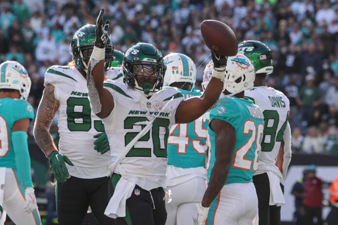 Breece Hall celebrates after scoring a touchdown against the Miami Dolphins.