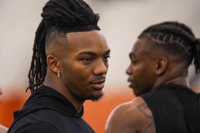 Texas running back Bijan Robinson watches on as teammates perform drills at Texas' Pro Day.