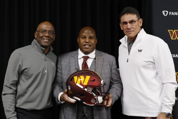 Eric Bieniemy poses with Washington Commanders general manager Martin Mayhew and Commanders head coach Ron Rivera.