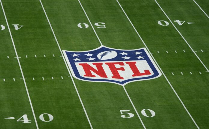 The NFL logo at midfield at Super Bowl 57.