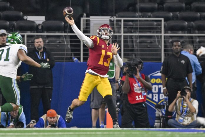 USC Trojans quarterback Caleb Williams (13) passes for a first down against the Tulane Green Wave during the second half in the 2023 Cotton Bowl at AT&T Stadium.