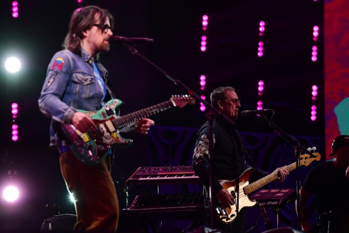Weezer bassist Scott Shriner and lead vocalist Rivers Cuomo perform following the first round of the 2022 NFL Draft.