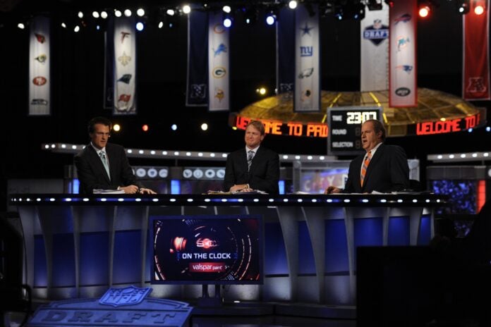 ESPN analyst Mel Kiper Jr analyst Jon Gruden and host Chris Berman (L to R) during the 2011 NFL Draft at Radio City Music Hall.