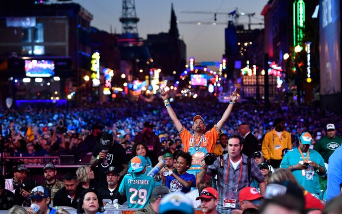 A fan cheers during the second day of the NFL Draft.
