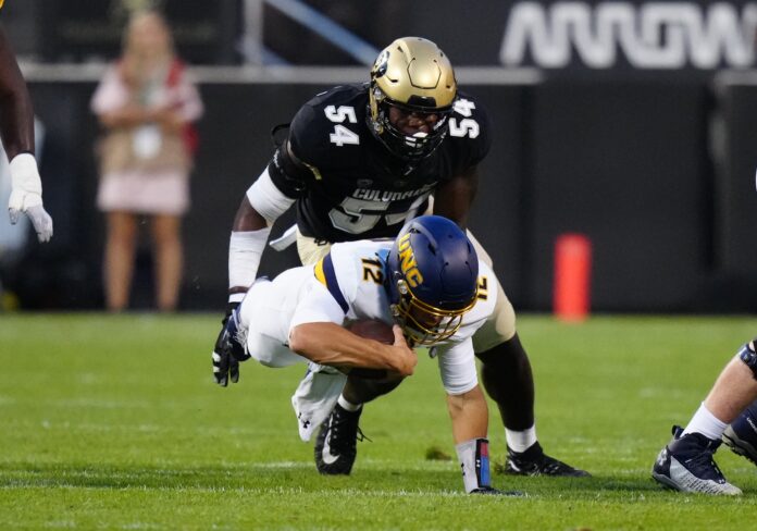 Dylan Mccaffrey (12) dives away from Colorado Buffaloes defensive end Terrance Lang (54).