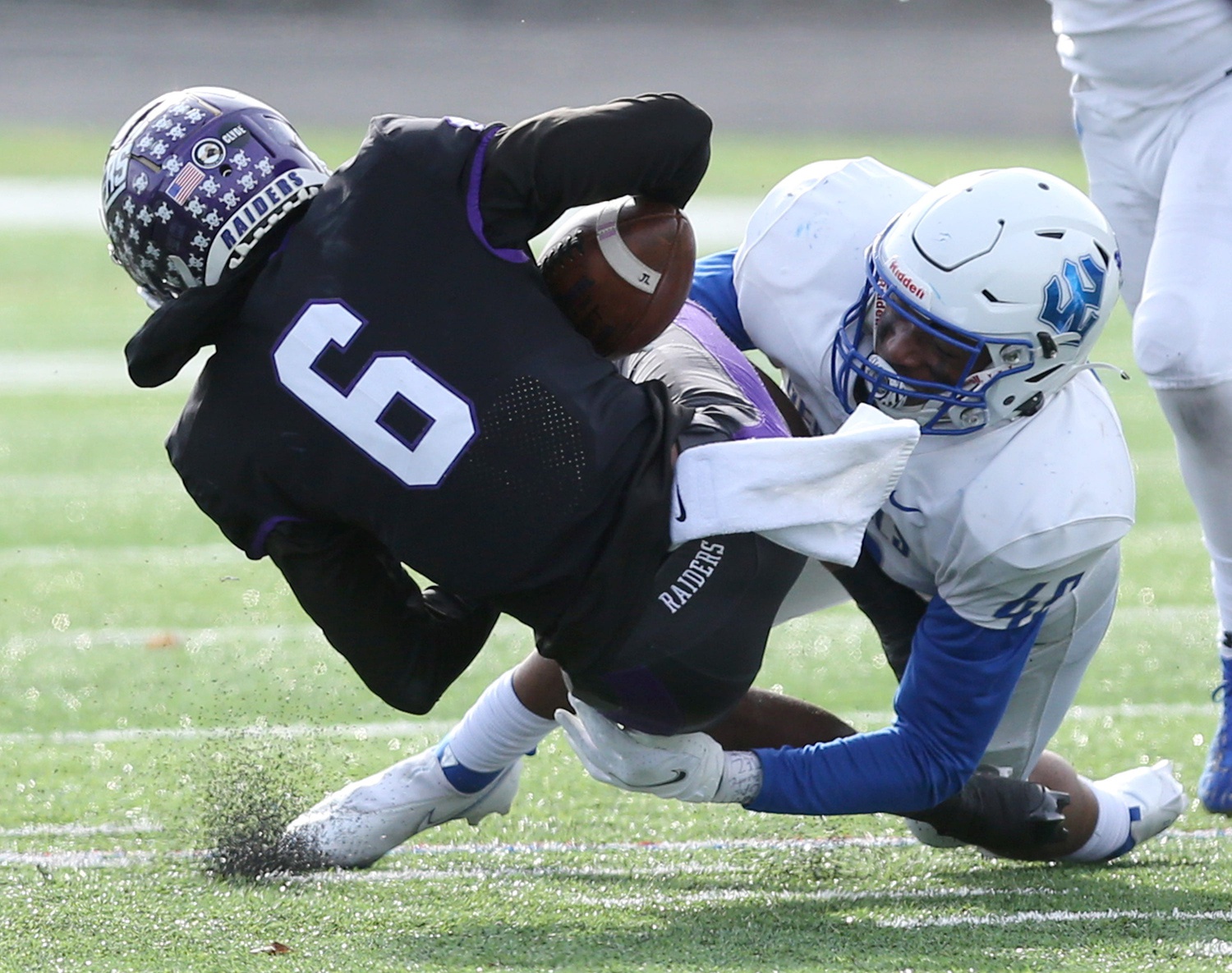 Wayne Ruby, Jr., 6, of Mount Union is tackled by Jalen Todd.