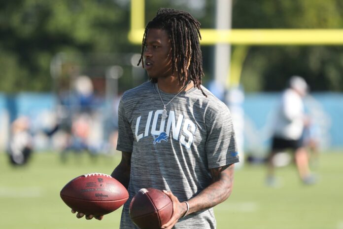 Detroit Lions WR Jameson Williams watches passing drills during practice.