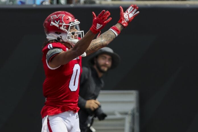 Miami Redhawks wide receiver Mac Hippenhammer (0) celebrates after scoring a touchdown against the Cincinnati Bearcats in the first half at Paycor Stadium.