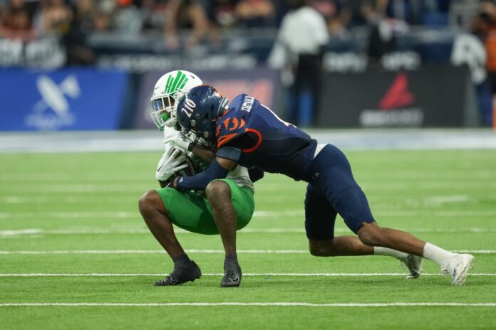 UTSA Roadrunners safety Clifford Chattman tackles North Texas Mean Green wide receiver Roderic Burns in the second half at the Alamodome.