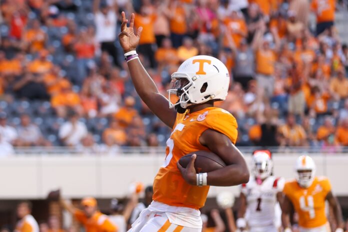 Tennessee QB Hendon Hooker (5) gestures towards the crowd after scoring a touchdown.