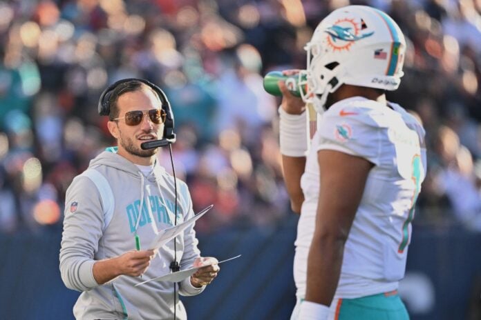 Miami Dolphins head coach Mike McDaniel talks to QB Tua Tagovailoa (1) during a stoppage in play.