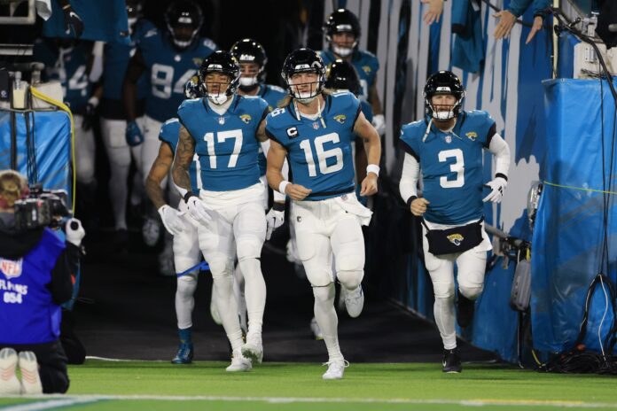 Trevor Lawrence (16) takes to the field with teammates before an NFL first round playoff football matchup between the Jacksonville Jaguars and the Los Angeles Chargers.
