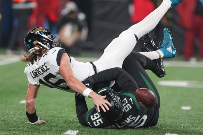 New York Jets DT Quinnen Williams (95) sacks and forces a fumble on Jacksonville Jaguars QB Trevor Lawrence (16).