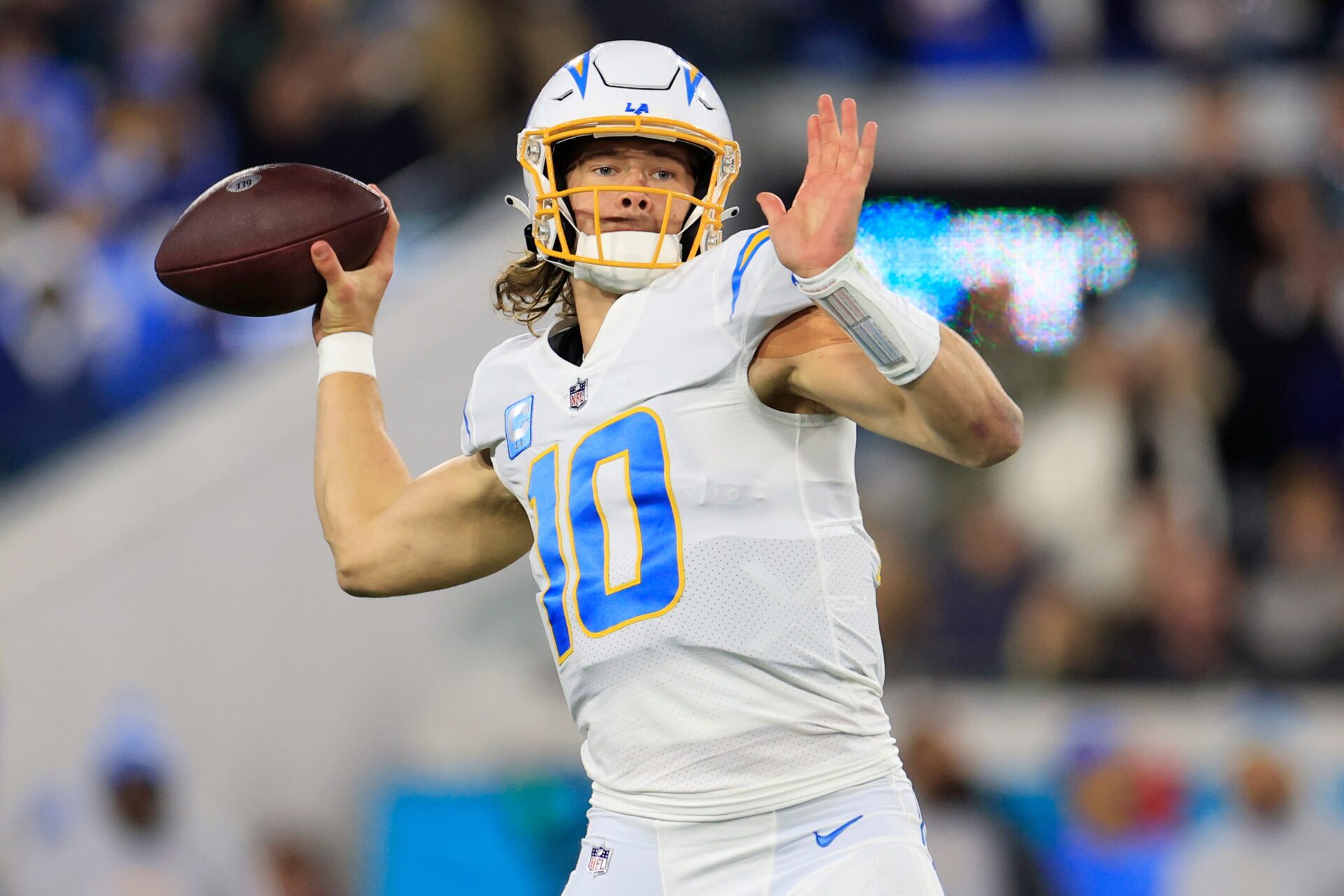 Justin Herbert looks to throw during the first quarter of an NFL first-round playoff football matchup.