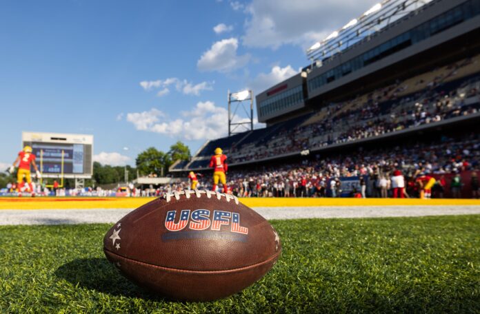 A USFL football on the ground during a game.
