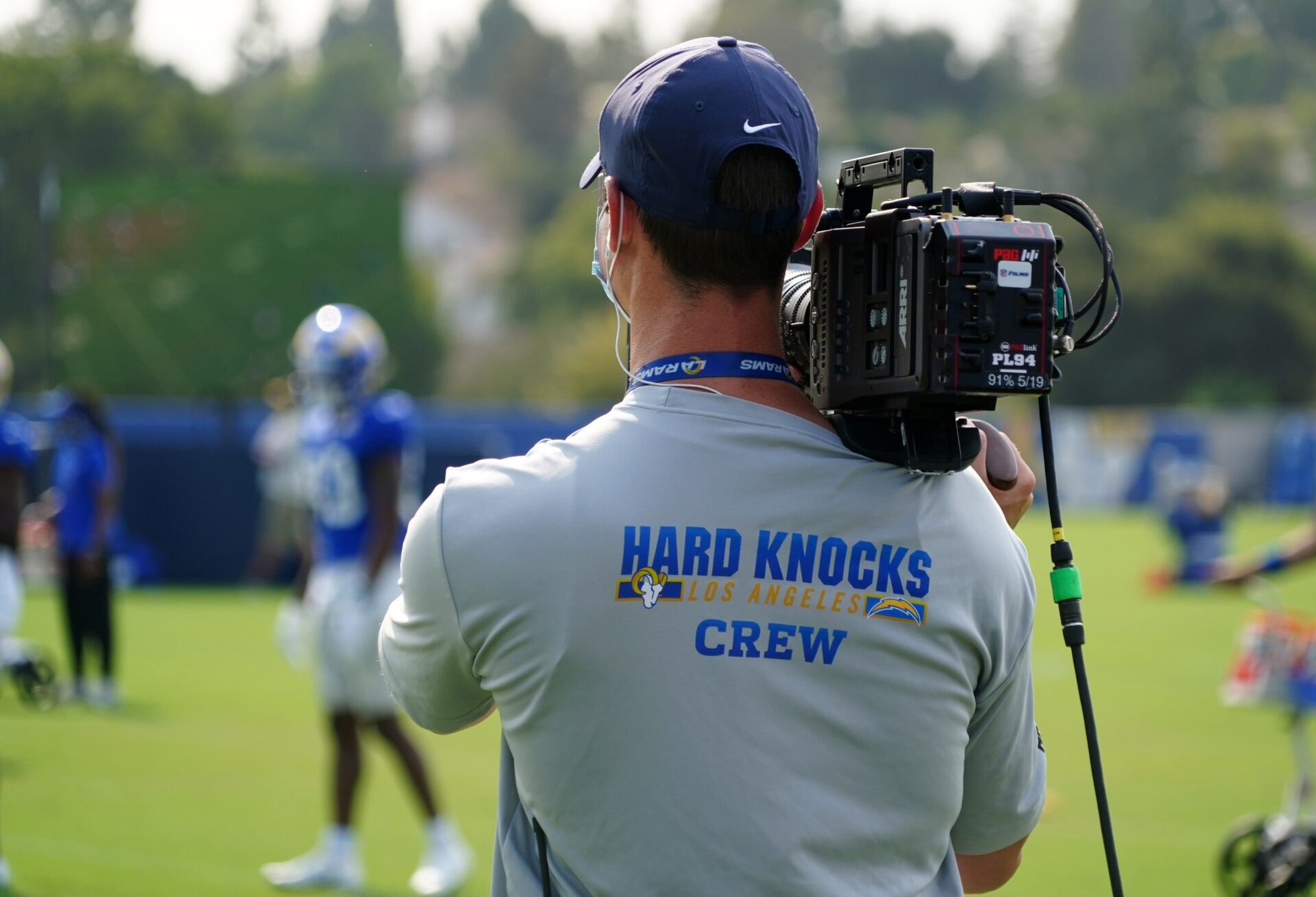 A Hard Knocks crew cameraman shoots footage at the Los Angeles Rams training camp.