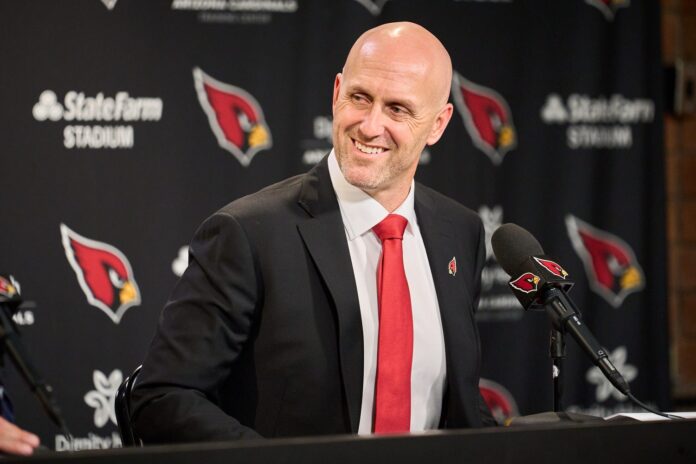 Arizona Cardinals' new general manager Monti Ossenfort smiles as team owner Michael Bidwill praises him during a news conference.