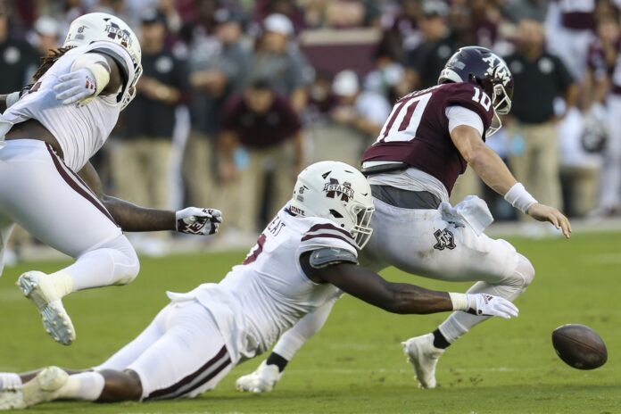 Mississippi State LB Tyrus Wheat (2) strips the ball from the Texas A&M quarterback.