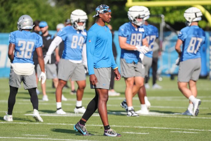 Detroit Lions QB Hendon Hooker watches the team's warmups during training camp.