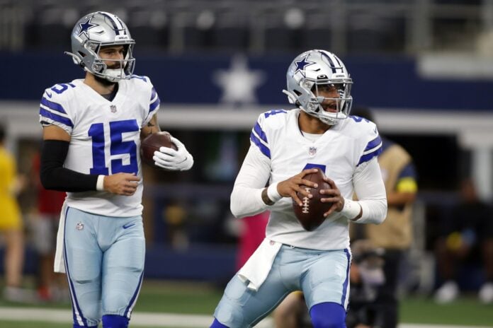 Dak Prescott (4) and quarterback Will Grier (15) throw passes during warmups before the game against the Seattle Seahawks.