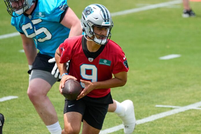 Bryce Young (9) hands off the ball during the Carolina Panthers rookie camp at the Atrium Practice Facility.