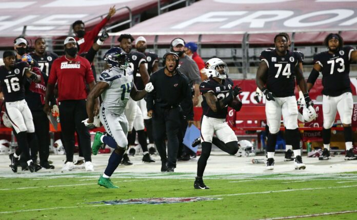 Seattle Seahawks WR DK Metcalf (14) chases down SS Budda Baker (32) after an interception.